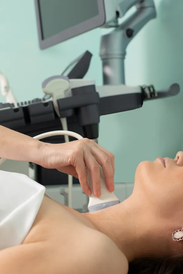 Hashimotos-Thyroiditis-Treatment A woman gets a thyroid scan from a doctor in a clinic. Get help with Hashimoto's Thyroiditis from Delara Tavakoli, M.D. of Tavicare in Chevy Chase.