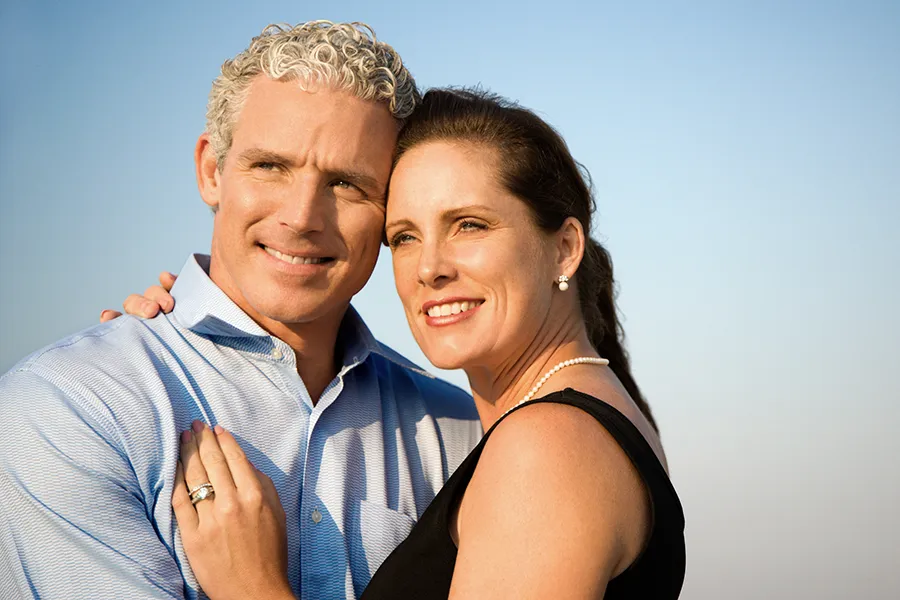 Healthy-Aging-Peptides-Doctor A middle-aged caucasian couple embraces in the sunshine, happy with the healthy aging peptide treatments from Delara Tavakoli, M.D. of Tavicare in Chevy Chase